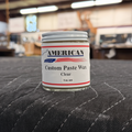 Six ounce jar of Rosini's American Custom Paste Wax on a table in a workshop setting.